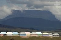 Huts imitating indian dwellings. A tepuy in the background. Gran Sabana, south of Venezuela.